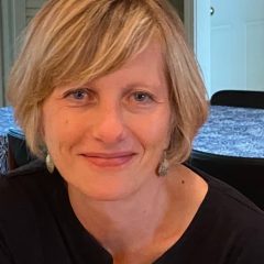 Headshot of white woman in black shirt smiling